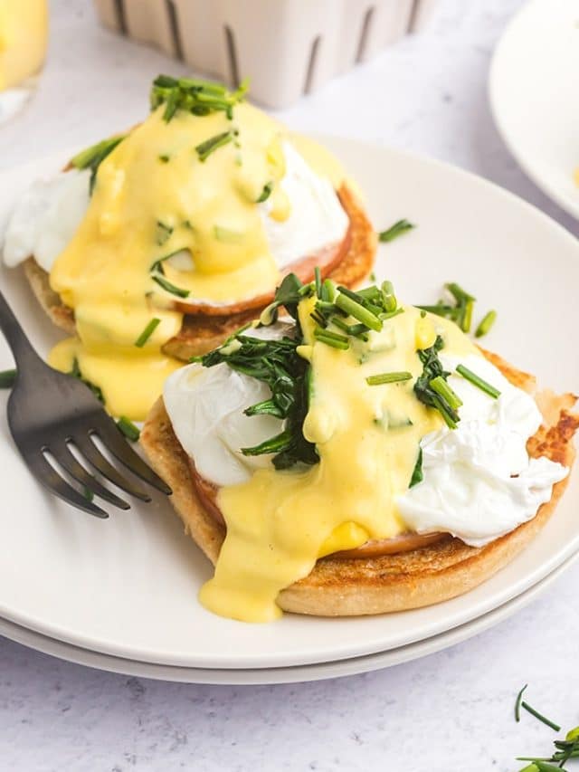 angled shot of eggs benedict on plate