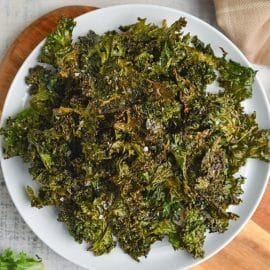 overhead of kale chips in a white plate
