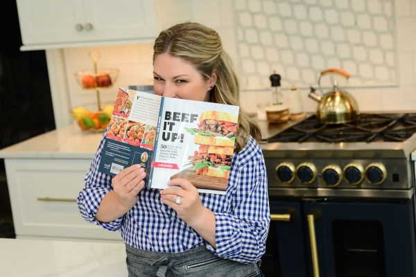 Jessica Formicola holding her cookbook Beef It Up!