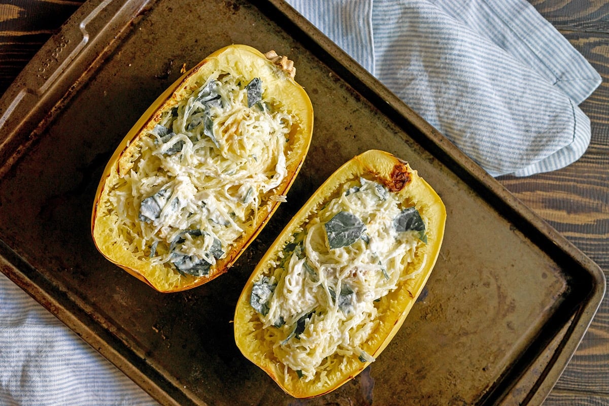 two spaghetti squash halves with ricotta filling