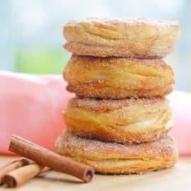 stack of cinnamon sugar donuts with pink linen