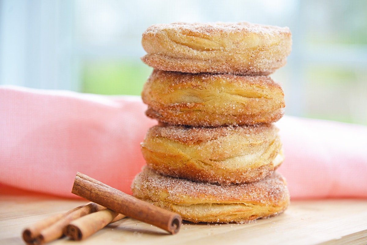 stack of cinnamon sugar donuts with pink linen