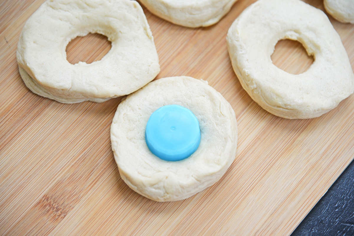 cutting a hole in a refrigerated biscuit