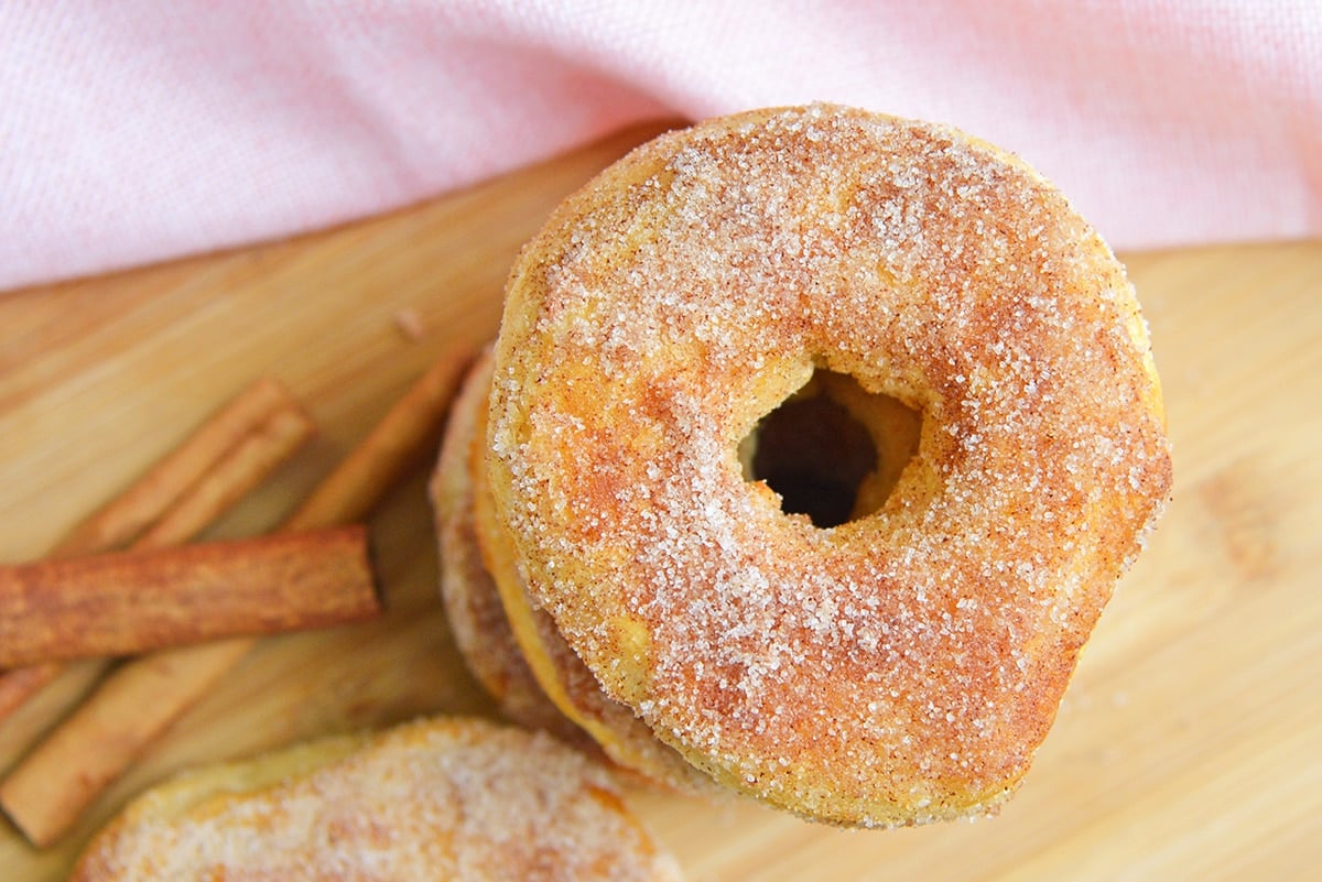 close up of a cinnamon sugar donut on wood background