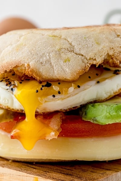 egg yolk dripping out of breakfast sandwich