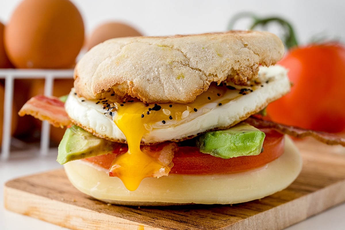 egg yolk dripping out of breakfast sandwich
