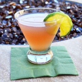 straight on shot of cosmo martini on fire pit ledge