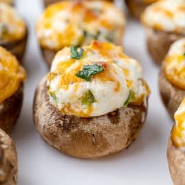 close up of cheesy stuffed mushrooms on a tray