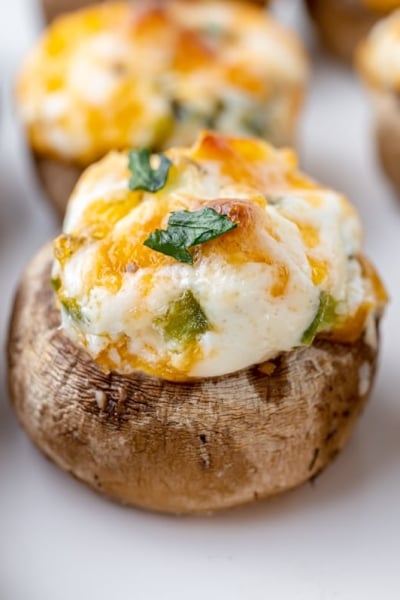 close up of cheesy stuffed mushrooms on a tray