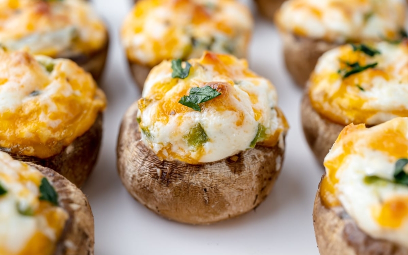 close up of cheesy stuffed mushrooms on a tray