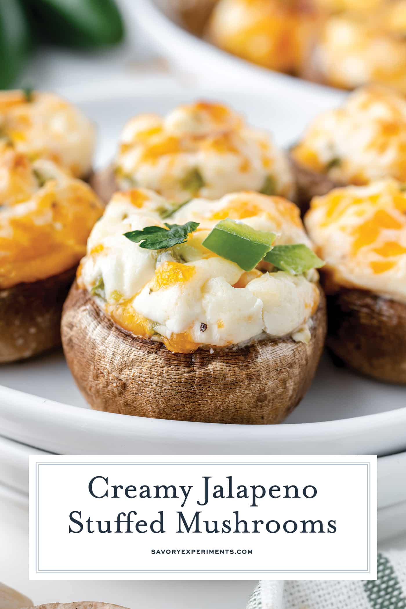 jalapeno stuffed mushrooms with text overlay for pinterest