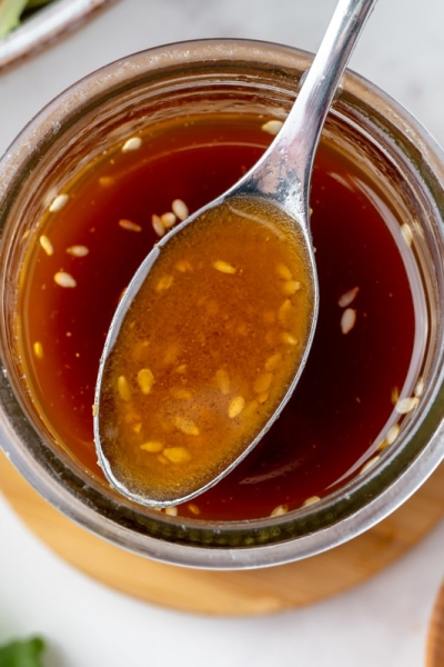 overhead shot of spoon in asian ginger salad dressing