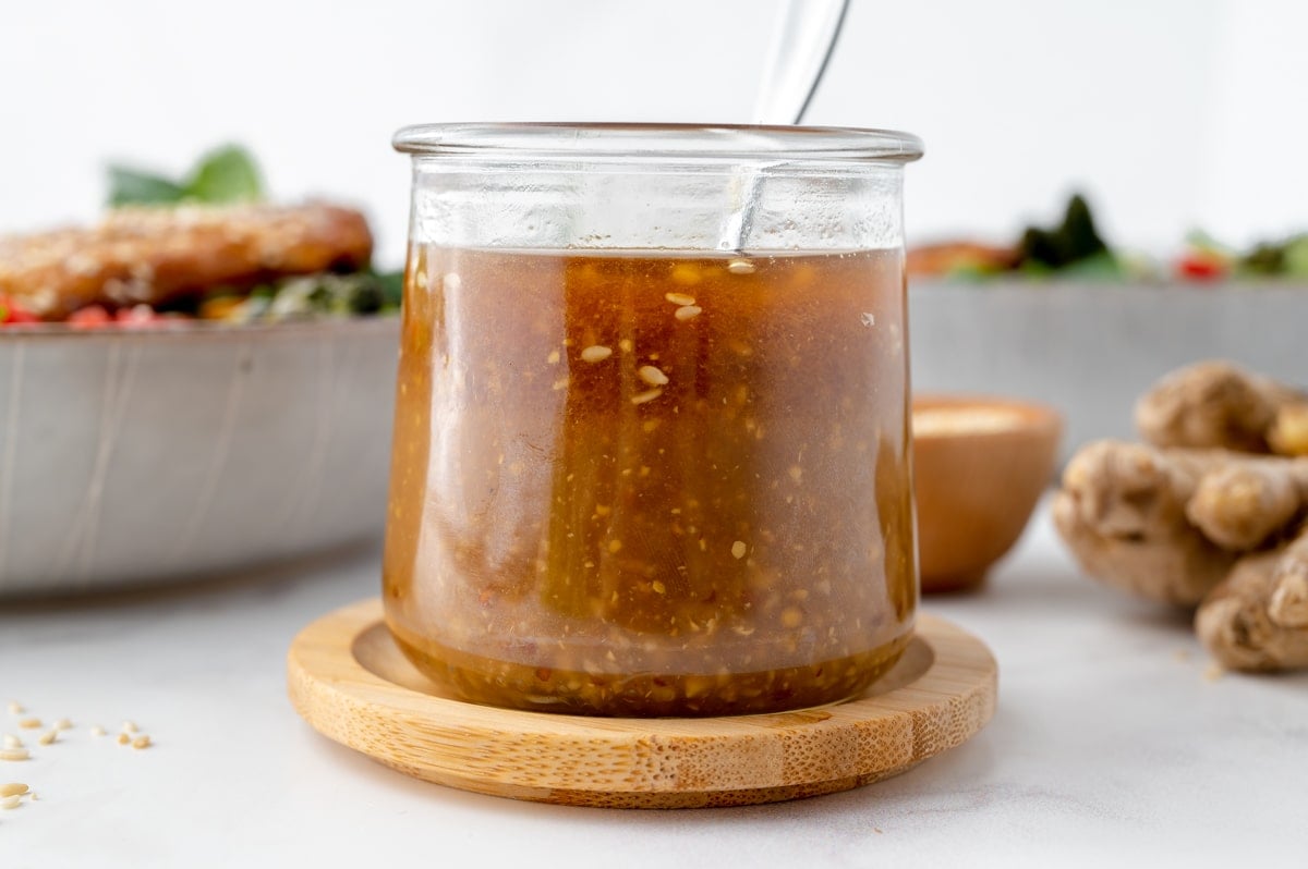 jar of ginger asian salad dressing with spoon in it