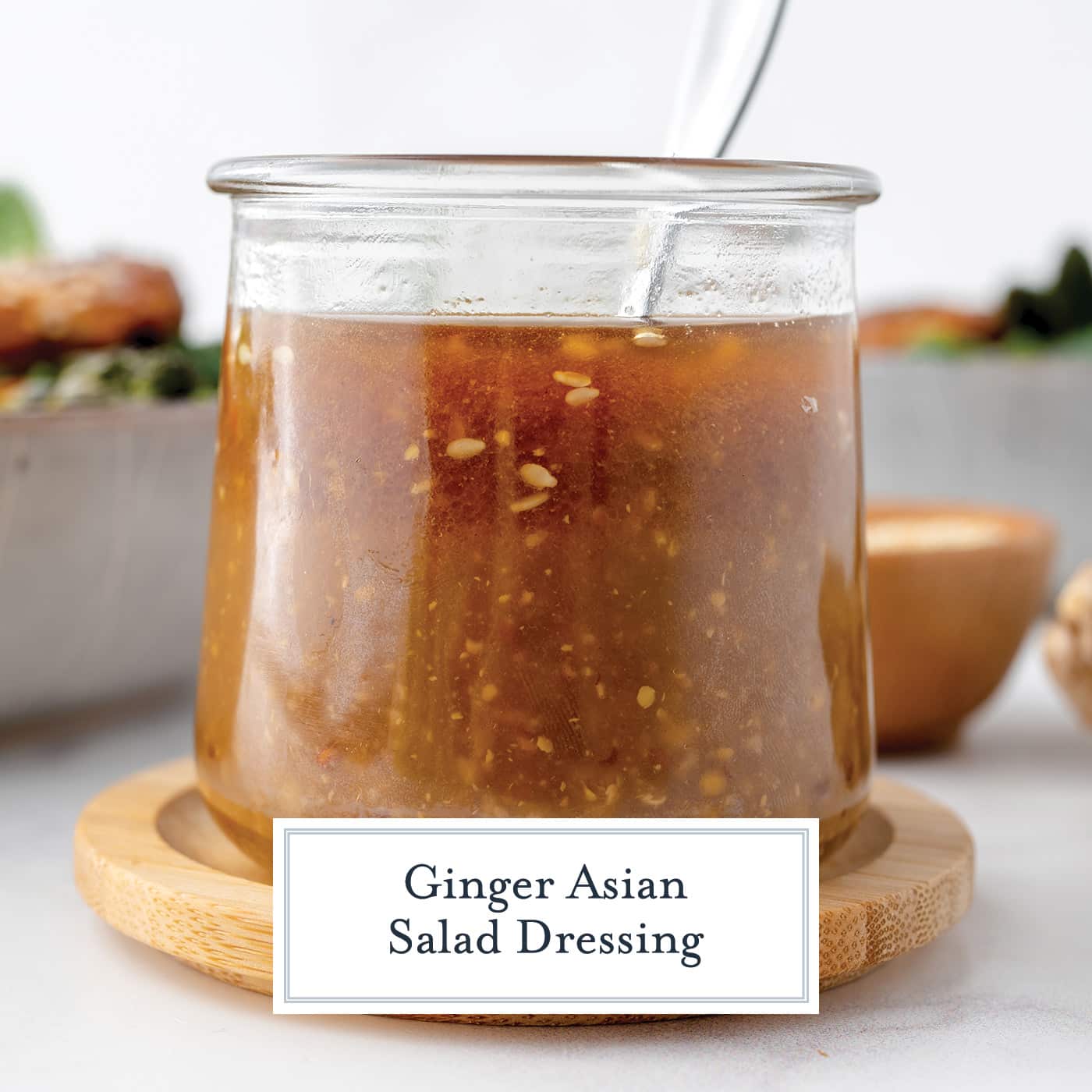 jar of ginger asian salad dressing with spoon in it with text overlay for facebook