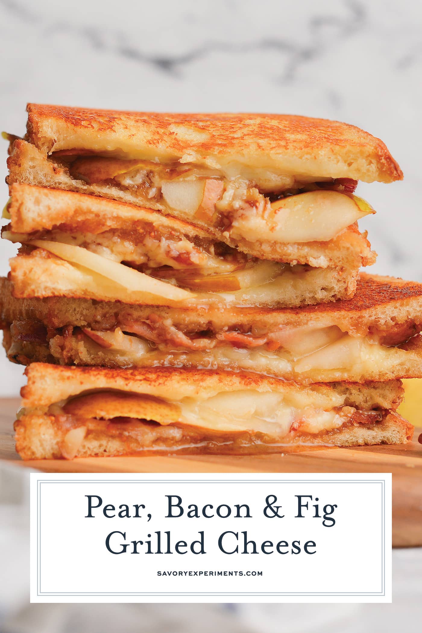 angle view of pear, bacon and fig grilled cheese sandwich
