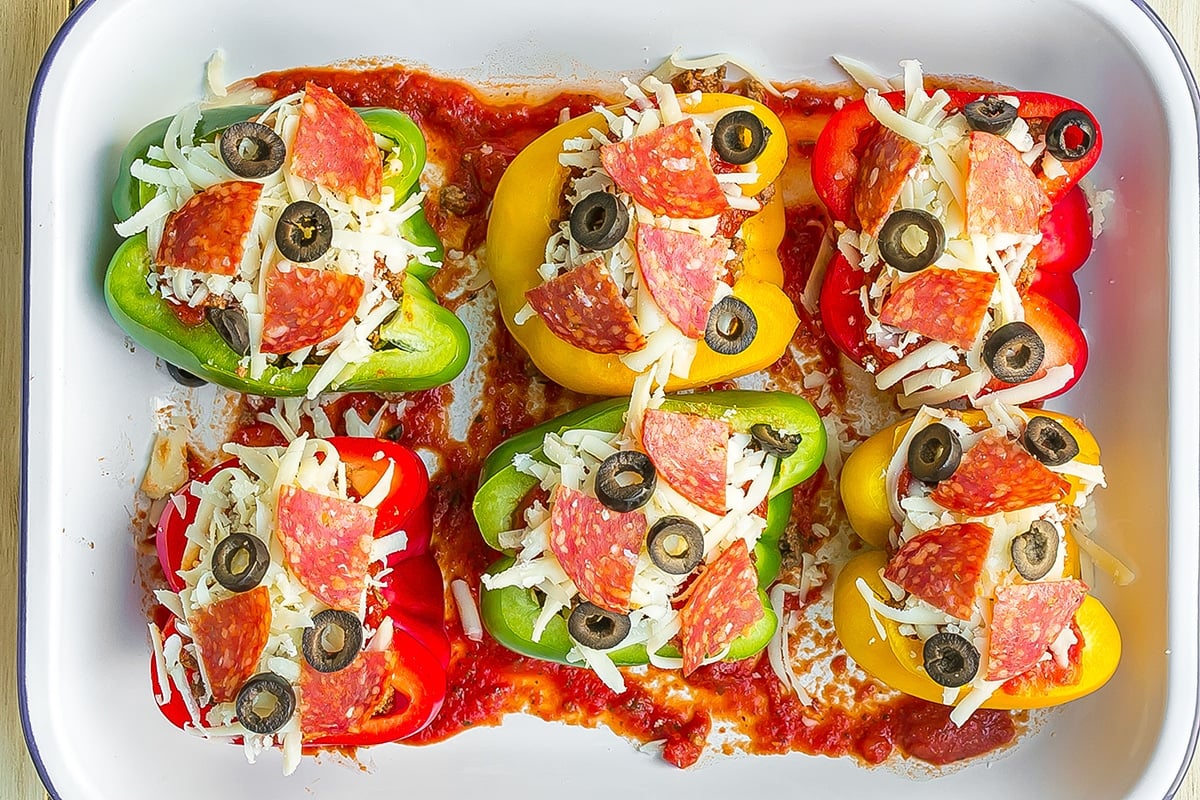 overhead shot of unbaked pizza stuffed peppers