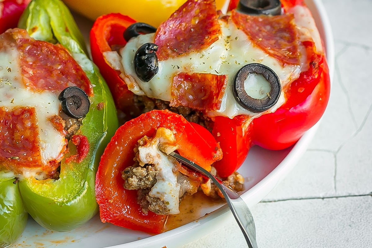 close up of bite of pizza stuffed pepper