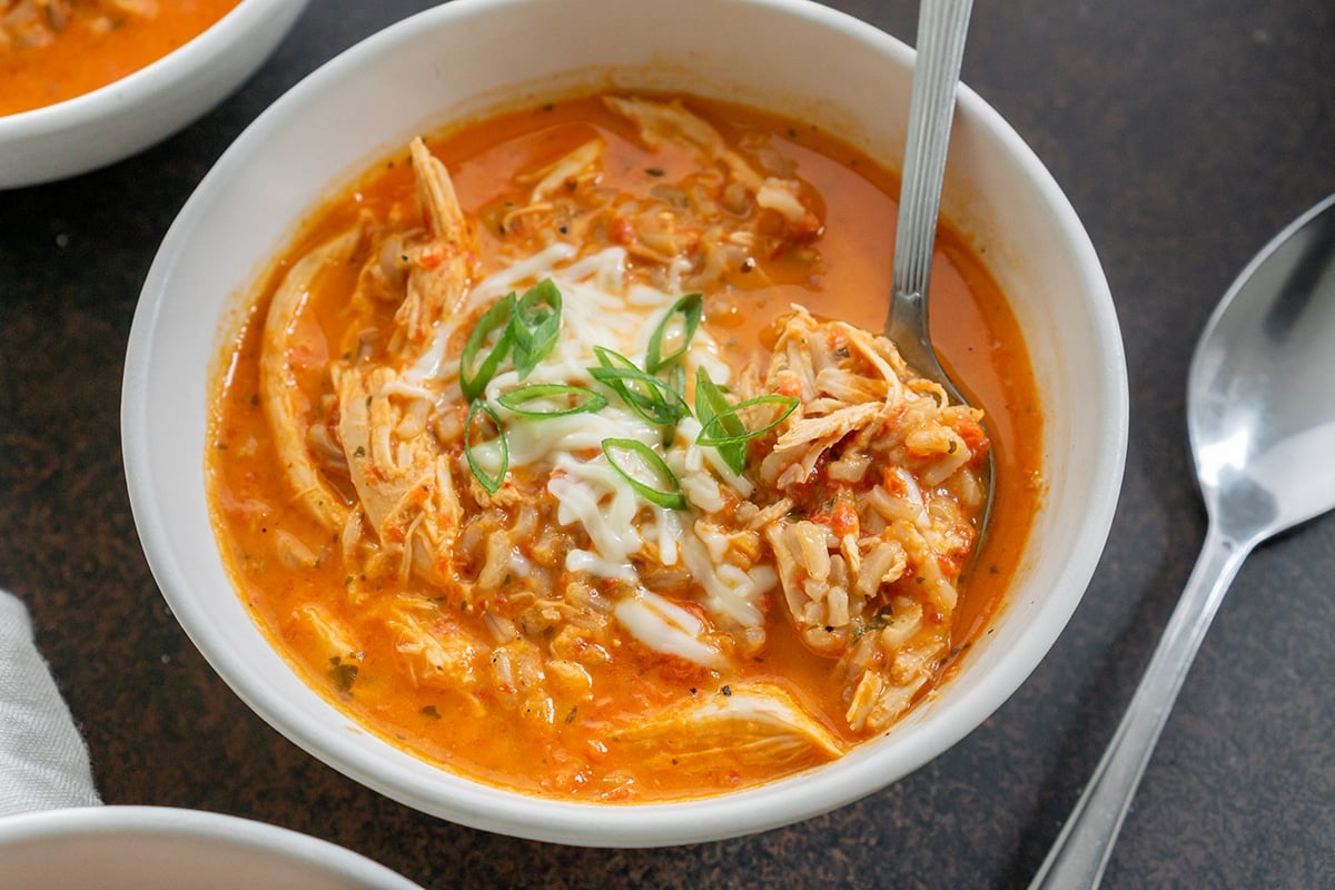 close up of roasted red pepper soup in a bowl