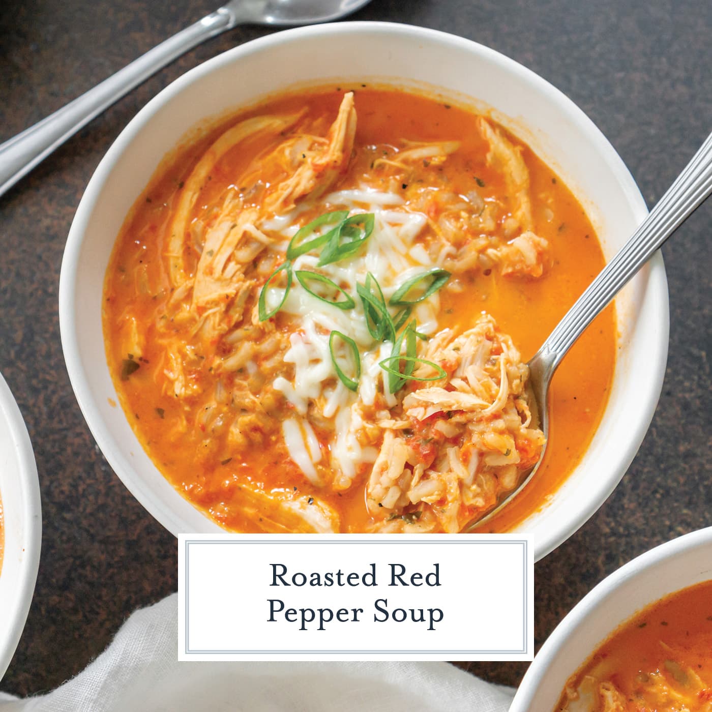 spoon in bowl of red pepper soup with text overlay for facebook