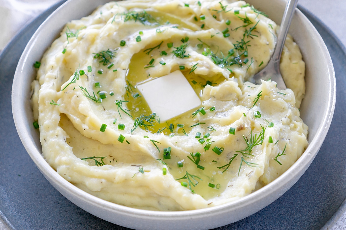 pat of butter on bowl of dill mashed potatoes