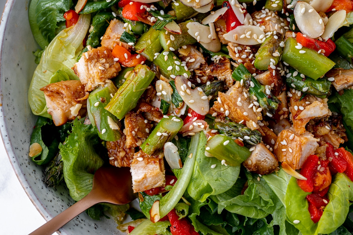 close up of sticky chicken salad chopped in a bowl