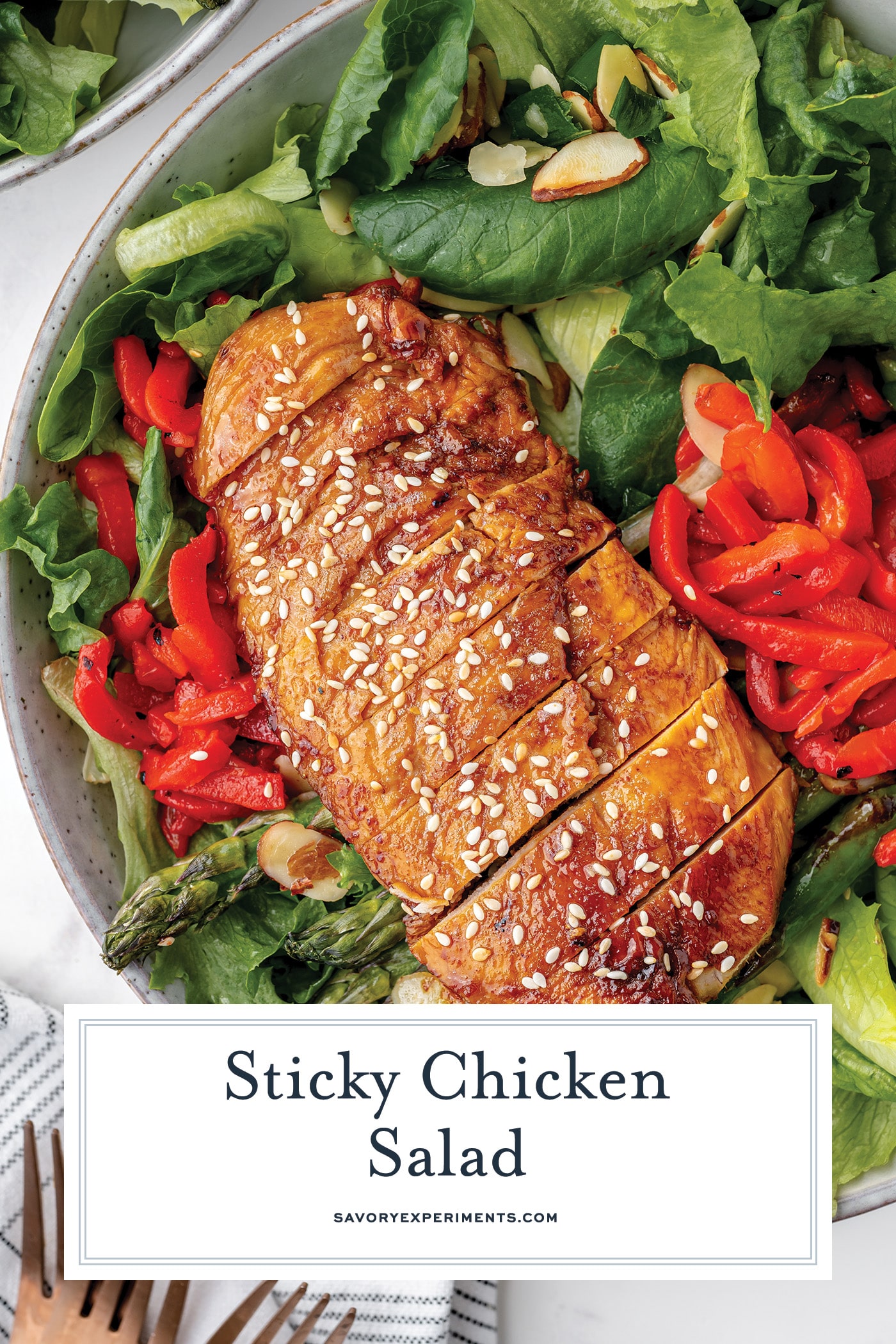 sliced sticky chicken on salad with text overlay for pinterest