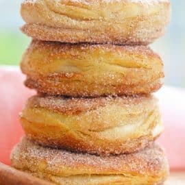 stack of cinnamon sugar donuts with pink linen