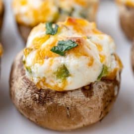 close up of cheesy stuffed mushrooms on a tray