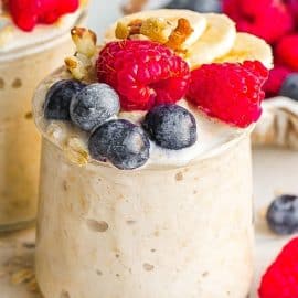 two jars of overnight oats topped with berries