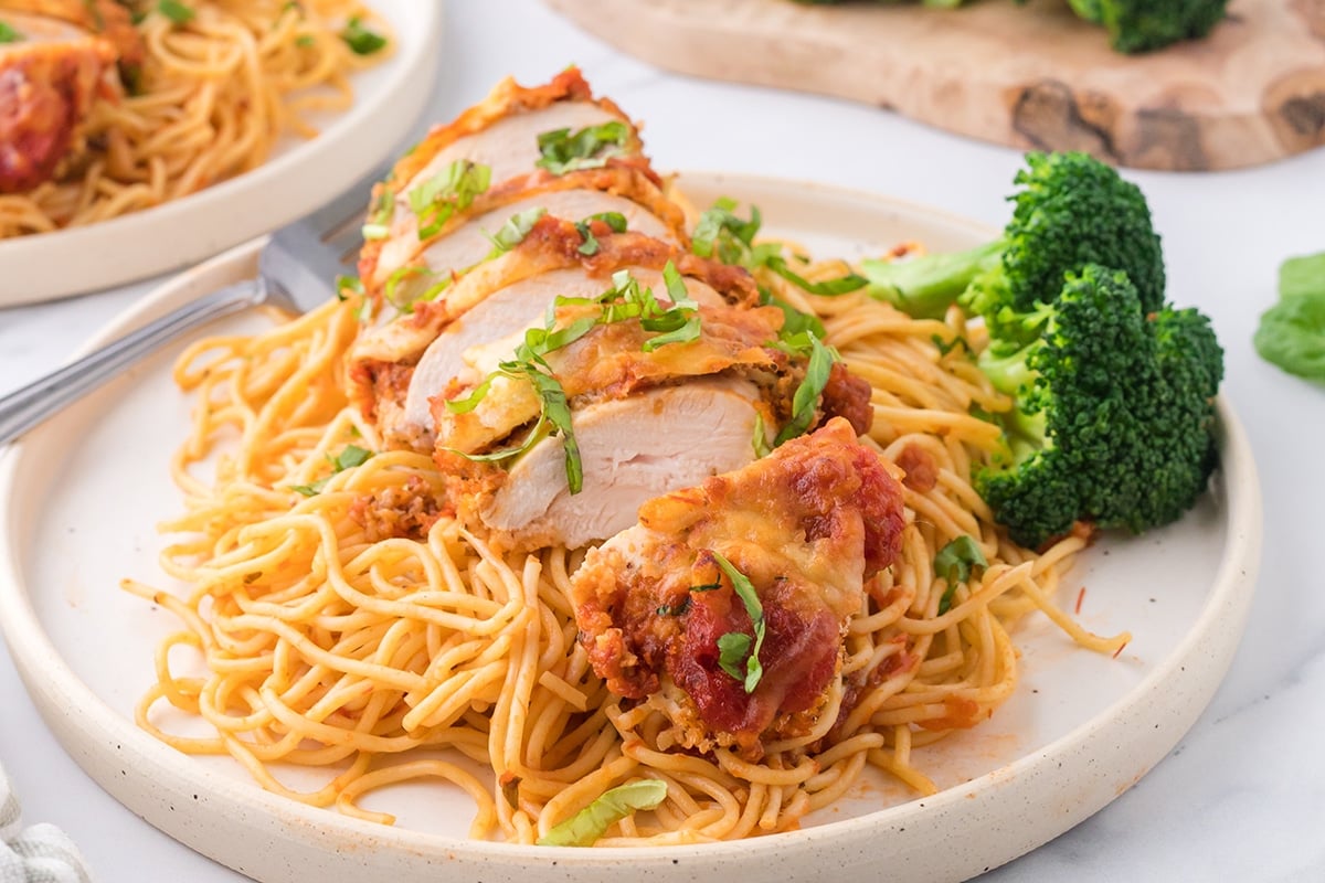 sliced air fryer chicken parmesan on plate