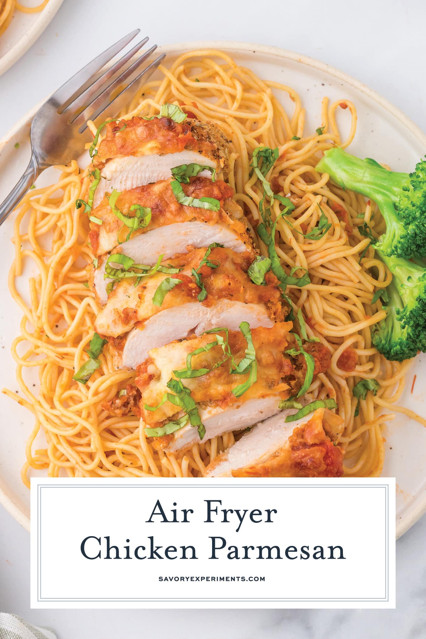 sliced air fryer chicken parmesan with text overlay for pinterest