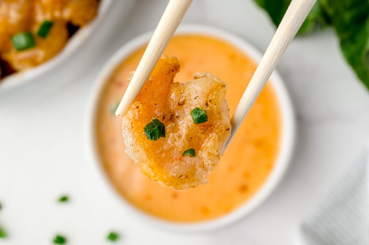 chopsticks holding one shrimp