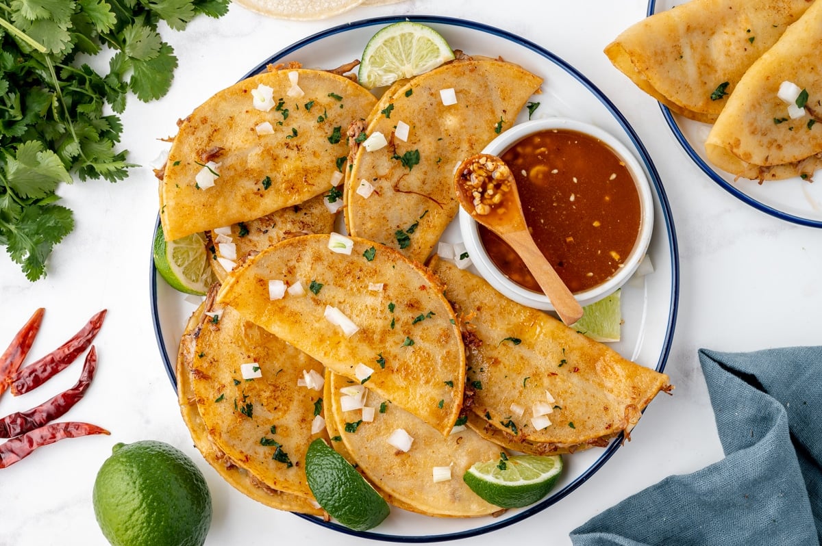 overhead shot of birria tacos on a plate