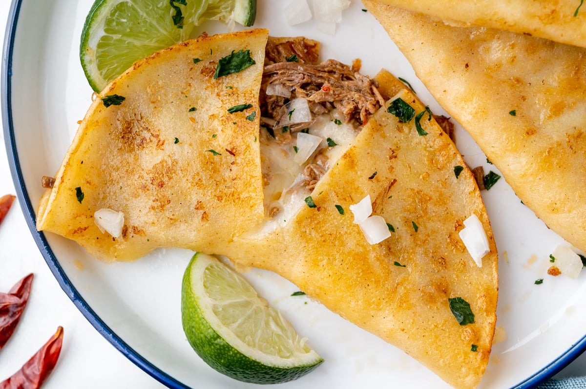 overhead shot of birria taco cut in half