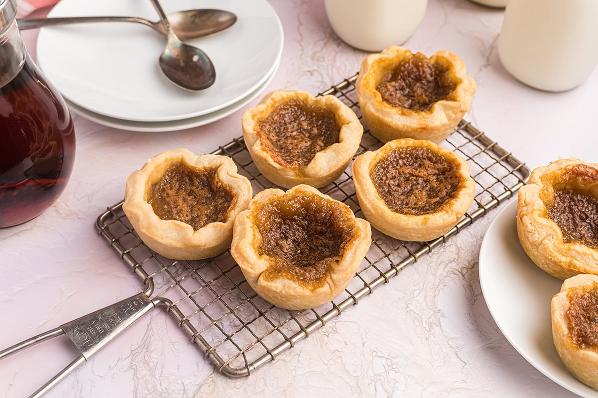 five canadian butter tarts on a wire tray