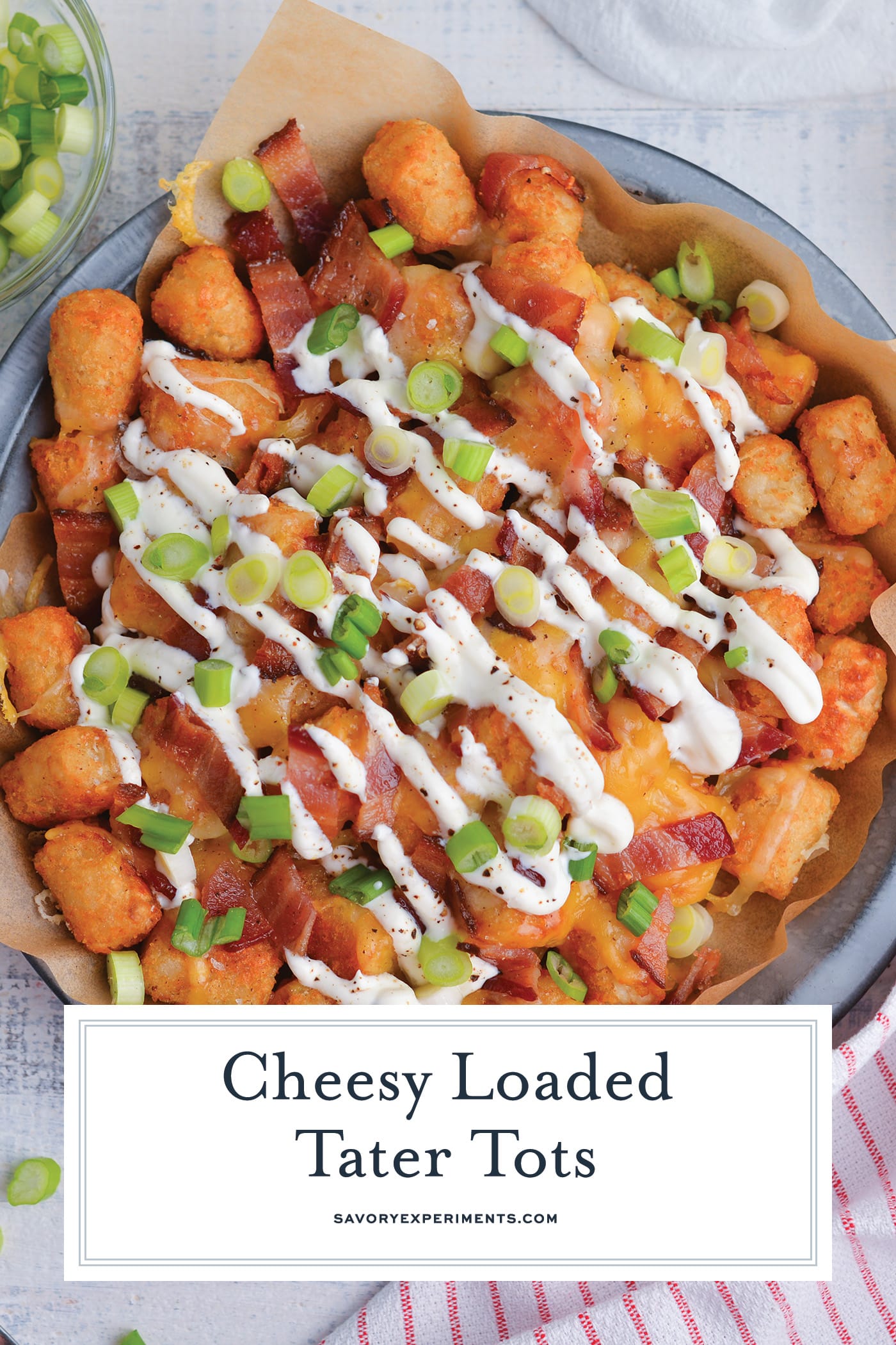 overhead shot of plate of cheesy loaded tater tots with text overlay for pinterest