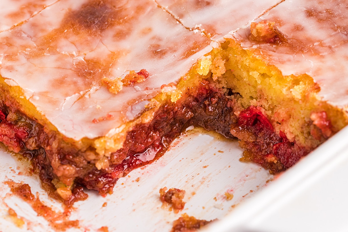 slice taken out of cherry honey bun cake