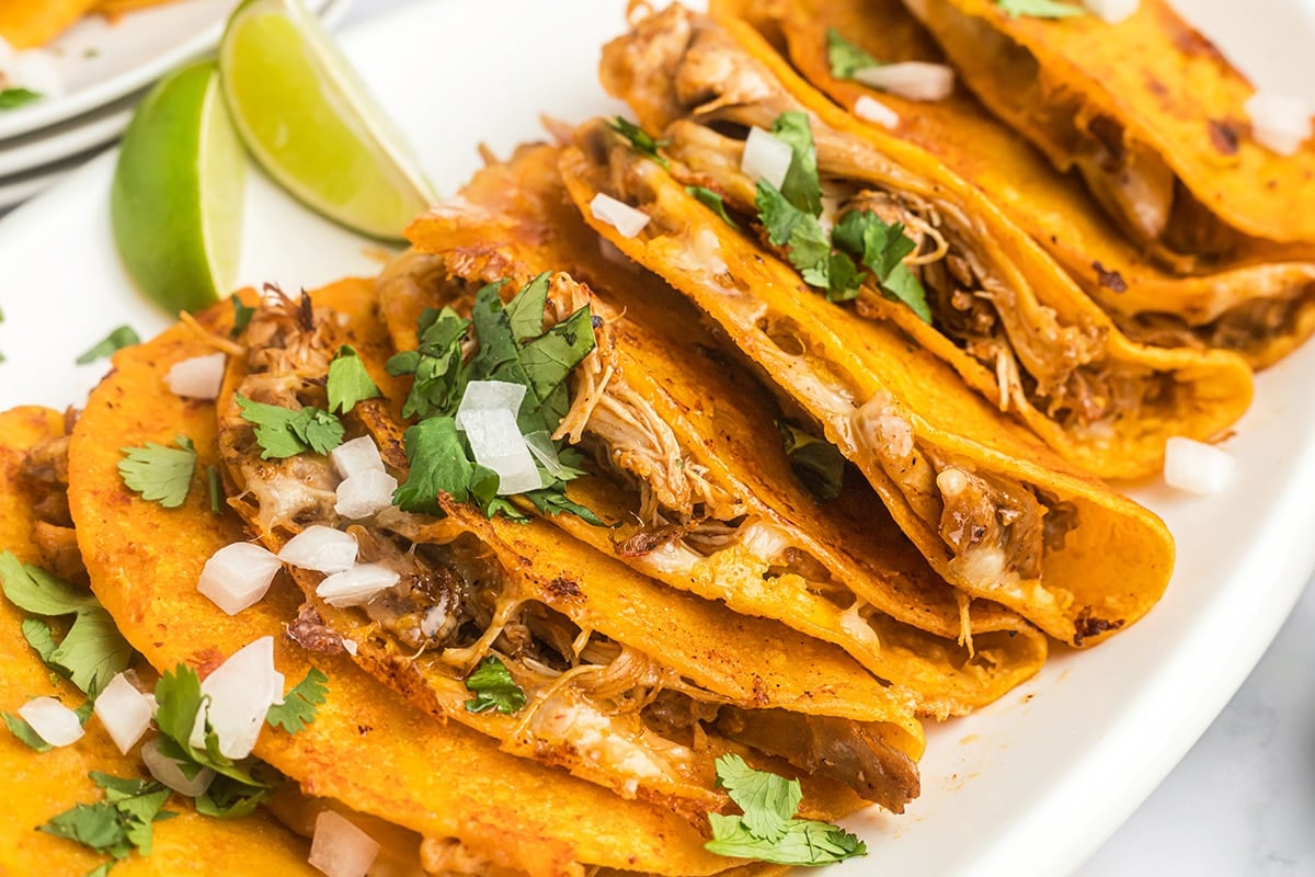 close up of birria tacos with toppings