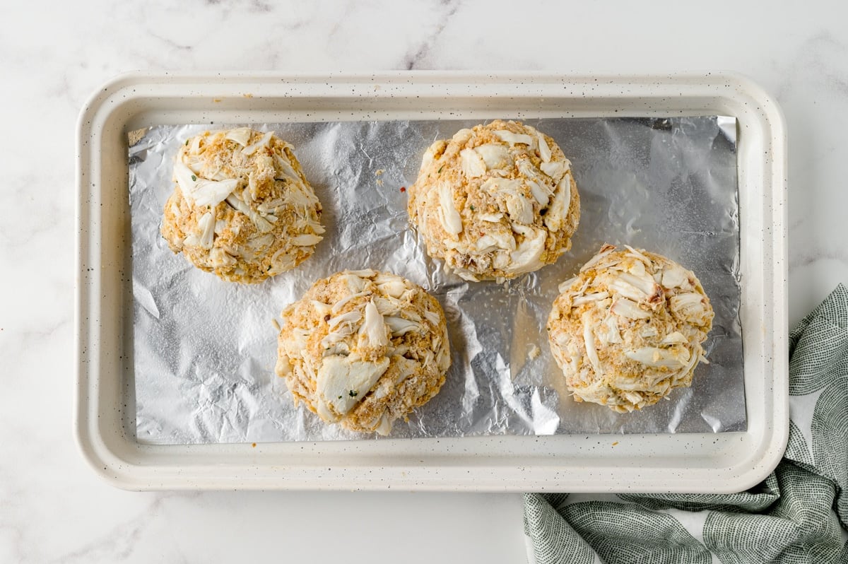 formed jumbo lump crab cakes on a baking sheet