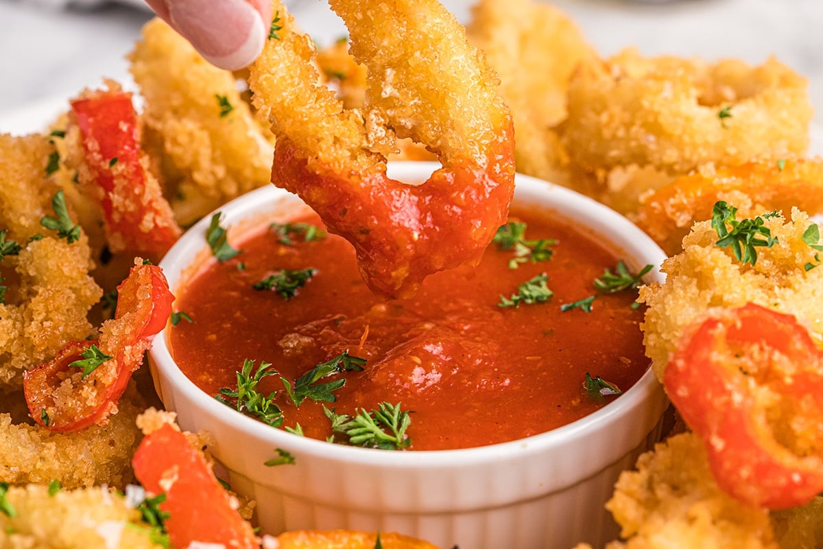 calamari dipping into marinara sauce