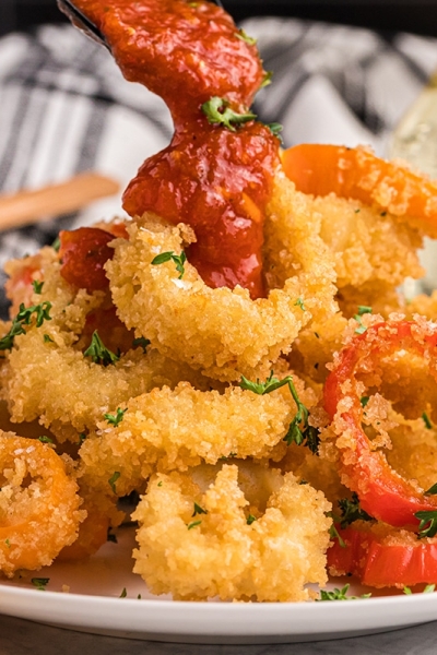 marinara poured onto fried calamari