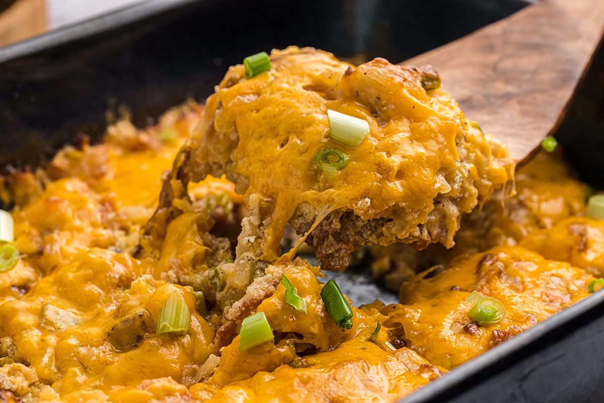 serving spoon taking slice of funeral potatoes