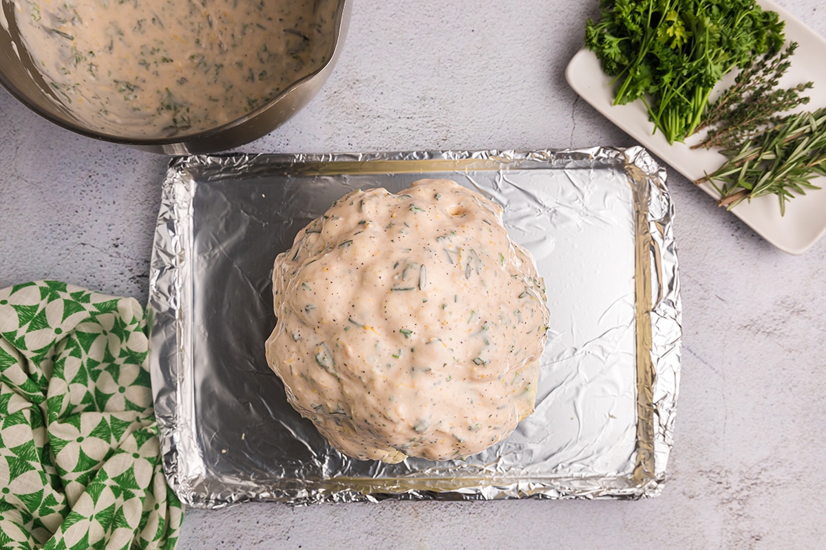 cauliflower head covered in creamy sauce