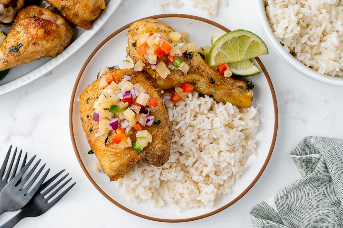 overhead shot of salsa over jerk chicken with rice