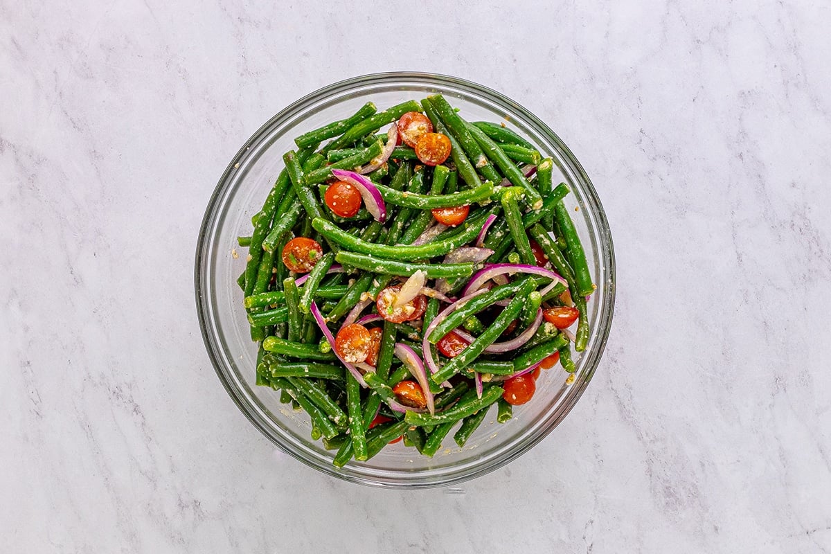 overhead shot of marinated green beans in a bowl