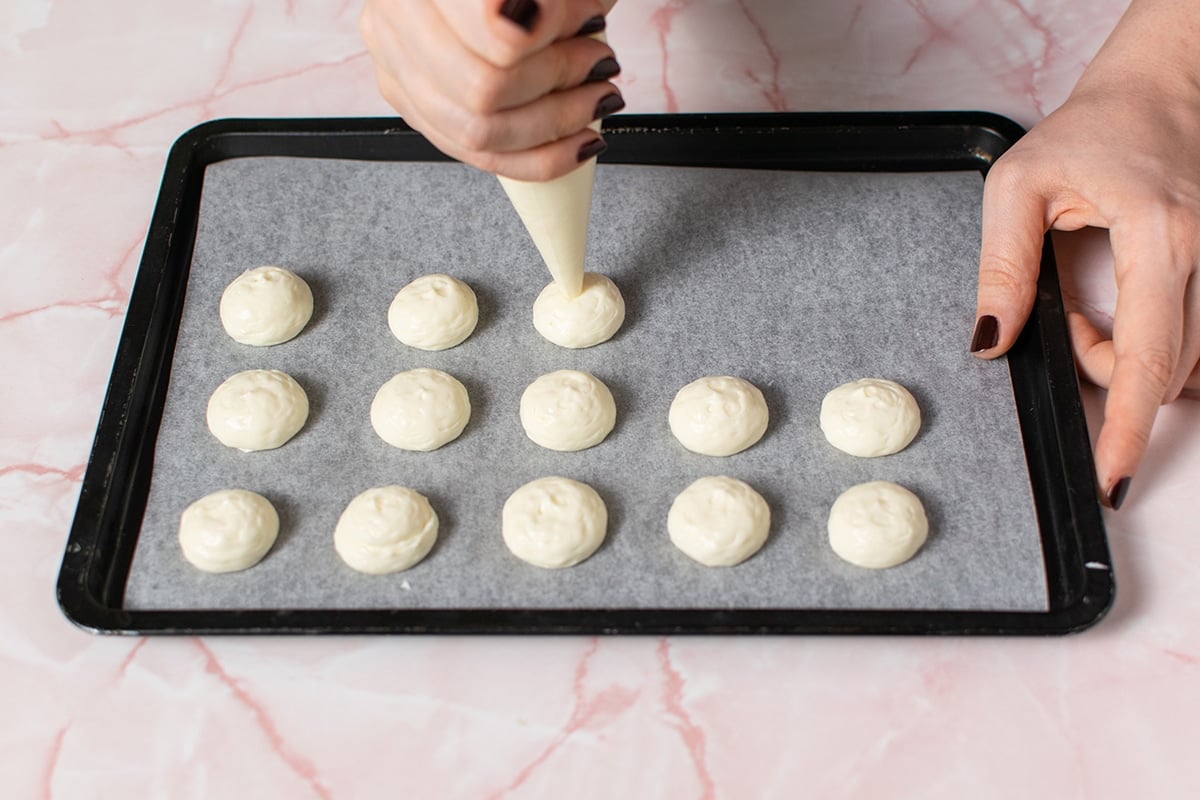 piping cream cheese filling on tray