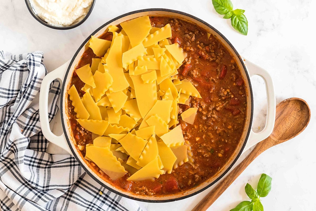 noodles and sauce added to pan of ground beef