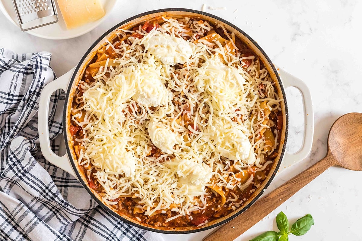 cheese sprinkled onto skillet lasagna