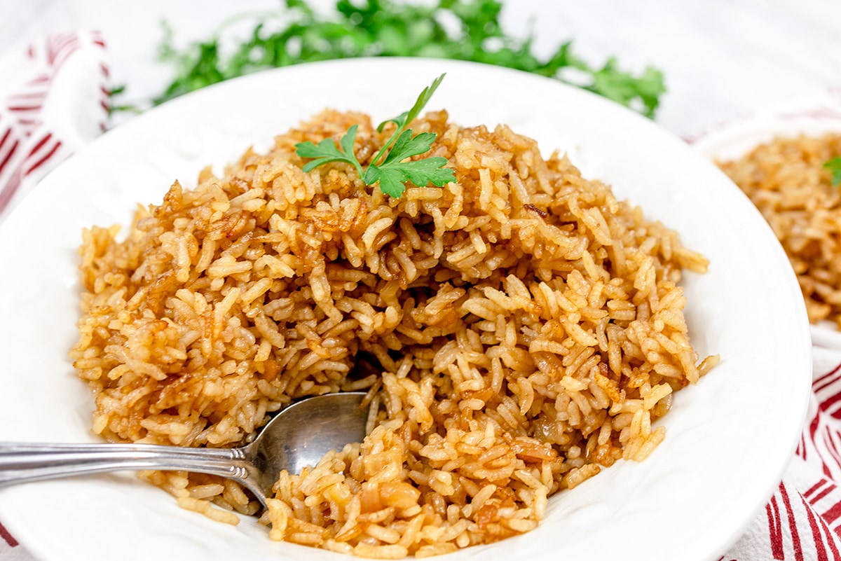 spoon in bowl of stick of butter rice