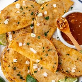 overhead shot of birria tacos on a plate